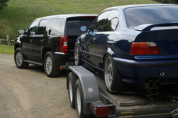 GMC Yukon Hybrid towing a loaded trailer